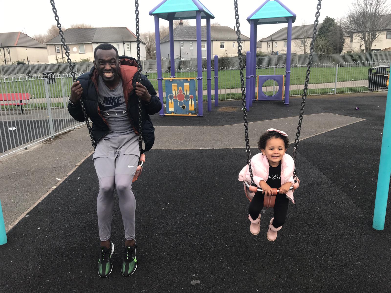 Emini on the swings with his daughter